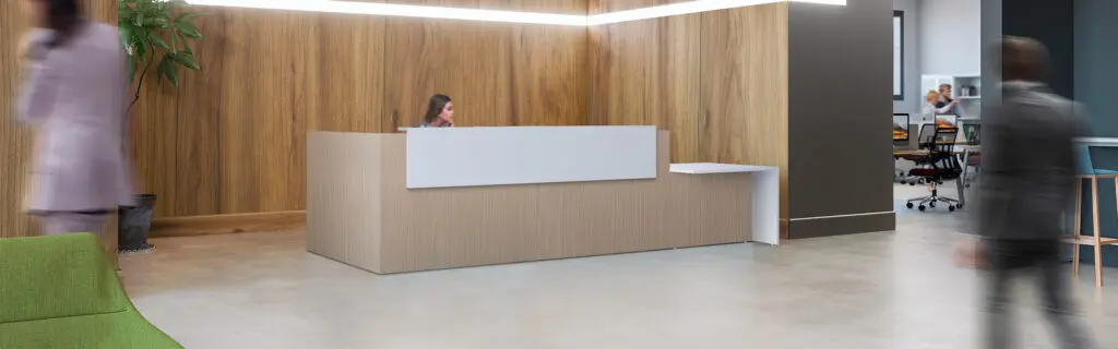 Reception desk with a woman behind the counter and people in front